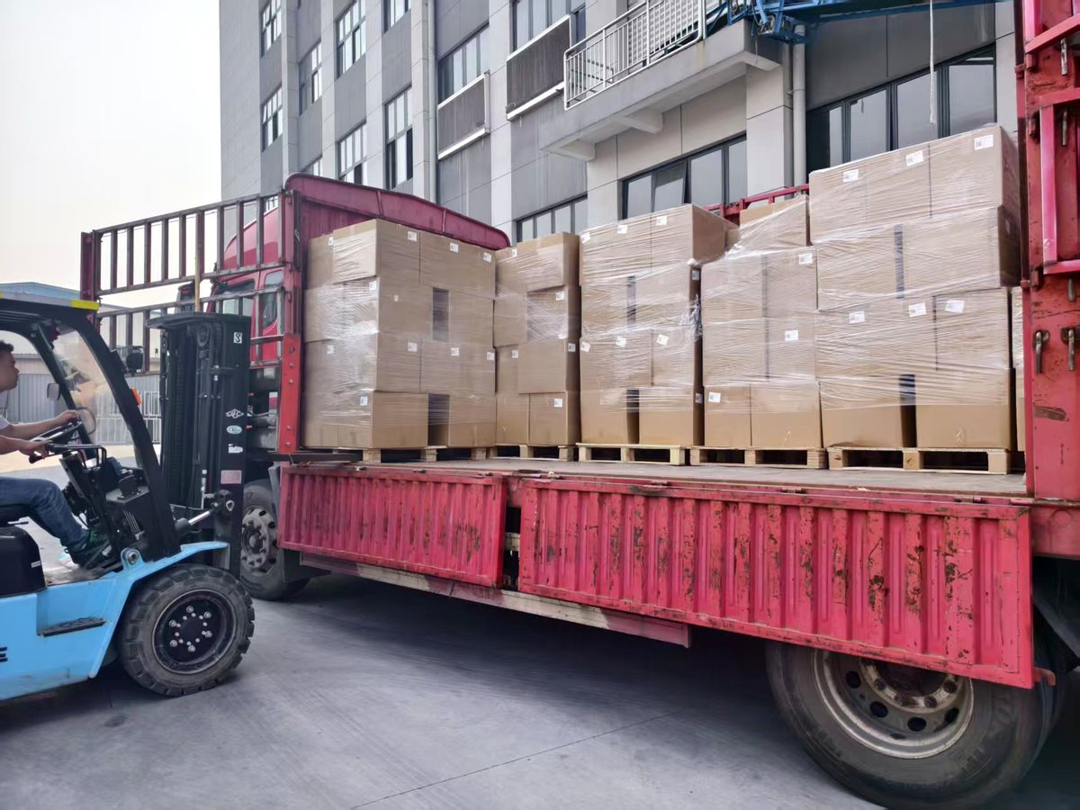 Forklift loading cartons onto truck
